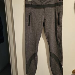 Gray Lululemon Leggings with Black Zipper Accents. Inseam 25